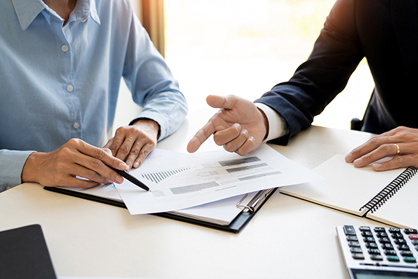personal investment banker going over paperwork with client