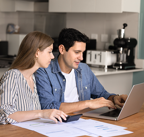 couple sitting at laptop planning financial matters while logged into online banking