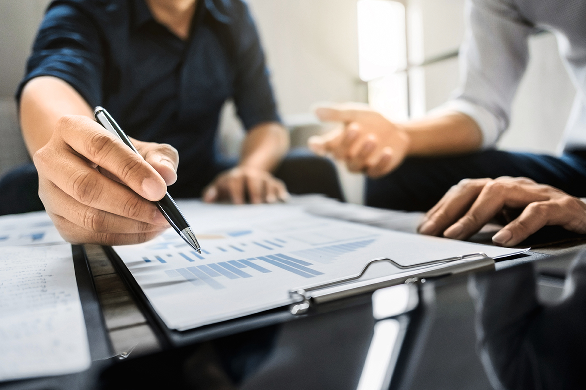 two people looking at data and pointing at spreadsheet